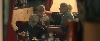 Movie still from “The Life Ahead” (2020), directed by Edoardo Ponti – An older man and a young woman sitting on a couch; Medium shot, Over the shoulder angle