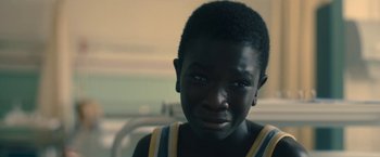 Movie still from “The Life Ahead” (2020), directed by Edoardo Ponti – A young person with a sad look on his face; Close Up shot, Over the shoulder angle
