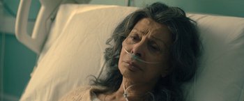 Movie still from “The Life Ahead” (2020), directed by Edoardo Ponti – An older woman laying in a hospital bed with an oxygen mask in her mouth; Close Up shot, High angle