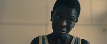 Movie still from “The Life Ahead” (2020), directed by Edoardo Ponti – A person wearing a tank top; Close Up shot, High angle