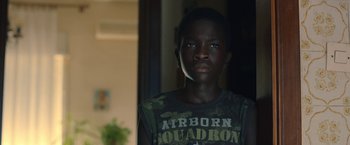 Movie still from “The Life Ahead” (2020), directed by Edoardo Ponti – A young boy is looking into the camera; Close Up shot, Low angle