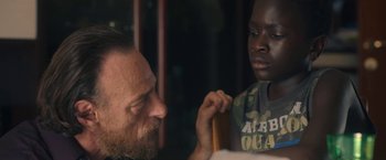 Movie still from “The Life Ahead” (2020), directed by Edoardo Ponti – A man and a boy looking at each other; Close Up shot, Over the shoulder angle