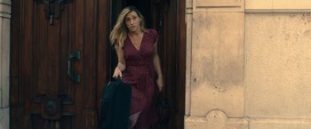 Movie still from “The Life Ahead” (2020), directed by Edoardo Ponti – A woman in a red polka dot dress carrying a suitcase; Medium shot, High angle