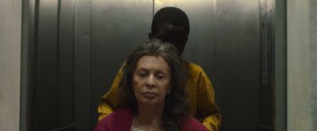 Movie still from “The Life Ahead” (2020), directed by Edoardo Ponti – An older woman getting her hair combed by a young man; Close Up shot, Over the shoulder angle