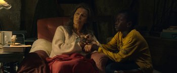 Movie still from “The Life Ahead” (2020), directed by Edoardo Ponti – An older woman sitting next to a young boy; Medium shot, High angle