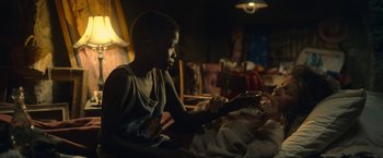 Movie still from “The Life Ahead” (2020), directed by Edoardo Ponti – A young boy sitting on a bed looking at a tablet; Medium shot, Over the shoulder angle