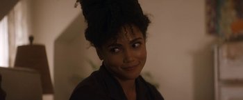 Movie still from “The Man from Toronto” (2022), directed by Patrick Hughes – A person with a hair bun; Close Up shot, Over the shoulder angle