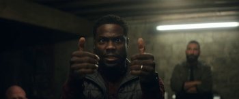 Movie still from “The Man from Toronto” (2022), directed by Patrick Hughes – A person with thumbs up; Close Up shot, Low angle