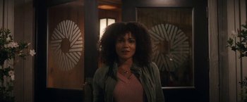 Movie still from “The Man from Toronto” (2022), directed by Patrick Hughes – A woman standing in front of a mirror; Medium shot, Over the shoulder angle