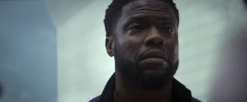 Movie still from “The Man from Toronto” (2022), directed by Patrick Hughes – A man's face looking upward; Close Up shot, Low angle