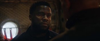 Movie still from “The Man from Toronto” (2022), directed by Patrick Hughes – A person looking at a camera; Close Up shot, Over the shoulder angle