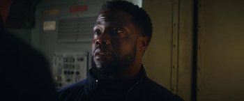 Movie still from “The Man from Toronto” (2022), directed by Patrick Hughes – A person with a beard; Close Up shot, Over the shoulder angle