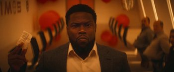 Movie still from “The Man from Toronto” (2022), directed by Patrick Hughes – A person wearing a suit and tie; Close Up shot, Low angle