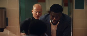 Movie still from “The Man from Toronto” (2022), directed by Patrick Hughes – Two men in a room with a table; Close Up shot, Over the shoulder angle