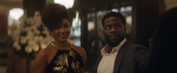 Movie still from “The Man from Toronto” (2022), directed by Patrick Hughes – A man and a woman standing next to each other; Close Up shot, Over the shoulder angle