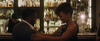 Movie still from “The Man from Toronto” (2022), directed by Patrick Hughes – A man and a woman in front of a bar; Medium shot, Over the shoulder angle