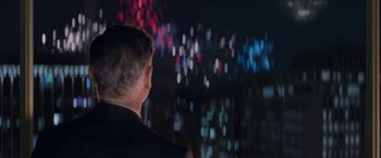 Movie still from “The Man from Toronto” (2022), directed by Patrick Hughes – A man in a suit looking at a screen; Close Up shot, Over the shoulder angle