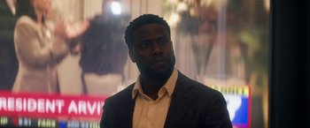 Movie still from “The Man from Toronto” (2022), directed by Patrick Hughes – A person wearing a suit and tie; Close Up shot, Low angle