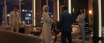 Movie still from “The Man from Toronto” (2022), directed by Patrick Hughes – A group of people standing in a living room; Wide shot, Over the shoulder angle