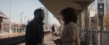 Movie still from “The Man from Toronto” (2022), directed by Patrick Hughes – A man and a woman are talking on a sidewalk; Medium shot, Over the shoulder angle