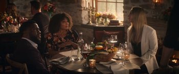 Movie still from “The Man from Toronto” (2022), directed by Patrick Hughes – A woman sitting at a table with a bowl of fruit; Medium shot, Over the shoulder angle