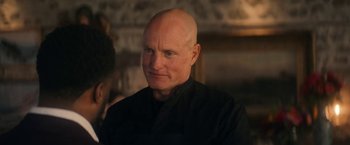 Movie still from “The Man from Toronto” (2022), directed by Patrick Hughes – A man with a bald head is looking at the camera; Close Up shot, Over the shoulder angle