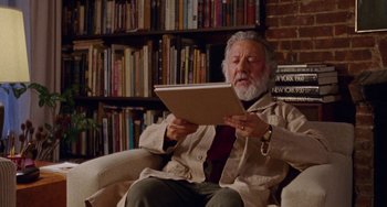Movie still from “The Meyerowitz Stories” (2017), directed by Noah Baumbach – An older man sitting in a chair looking at an open laptop computer; Medium shot, Low angle
