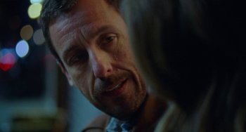 Movie still from “The Meyerowitz Stories” (2017), directed by Noah Baumbach – A man's face as he stares at the camera; Close Up shot, Over the shoulder angle