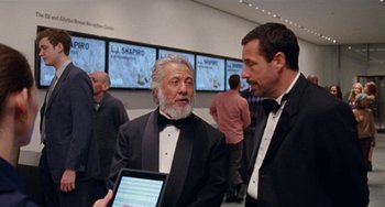 Movie still from “The Meyerowitz Stories” (2017), directed by Noah Baumbach – Two men in tuxedos are talking to each other; Medium shot, Over the shoulder angle