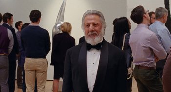 Movie still from “The Meyerowitz Stories” (2017), directed by Noah Baumbach – An older man in a tuxedo standing in front of people; Medium shot, Low angle