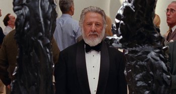 Movie still from “The Meyerowitz Stories” (2017), directed by Noah Baumbach – An older man in a tuxedo standing in front of some statues; Medium shot, Low angle
