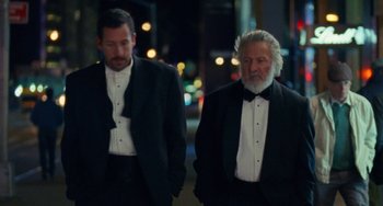 Movie still from “The Meyerowitz Stories” (2017), directed by Noah Baumbach – Two men in tuxedos walking down a street; Medium shot, Low angle