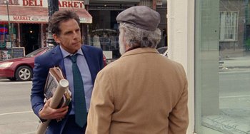 Movie still from “The Meyerowitz Stories” (2017), directed by Noah Baumbach – A man in a suit and tie talking to a man in a hat; Medium shot, Over the shoulder angle