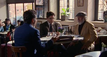 Movie still from “The Meyerowitz Stories” (2017), directed by Noah Baumbach – Three people sitting at a table in a restaurant; Medium shot, Over the shoulder angle