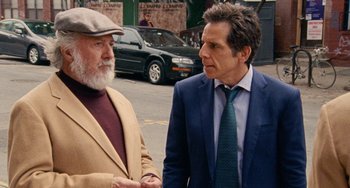Movie still from “The Meyerowitz Stories” (2017), directed by Noah Baumbach – Two men standing next to each other on the street; Medium shot, Over the shoulder angle