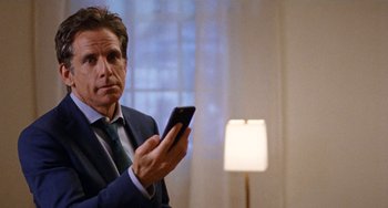 Movie still from “The Meyerowitz Stories” (2017), directed by Noah Baumbach – A man in a suit and tie holding a cell phone; Close Up shot, Over the shoulder angle