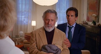 Movie still from “The Meyerowitz Stories” (2017), directed by Noah Baumbach – A man in a suit and tie standing next to another man in a suit and tie; Medium shot, Over the shoulder angle