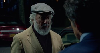 Movie still from “The Meyerowitz Stories” (2017), directed by Noah Baumbach – An older man wearing a hat talking to another man; Close Up shot, Over the shoulder angle