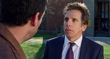 Movie still from “The Meyerowitz Stories” (2017), directed by Noah Baumbach – A man wearing a suit and tie talking to another man in a suit; Close Up shot, Over the shoulder angle