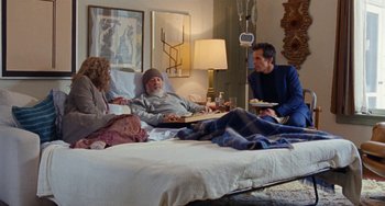 Movie still from “The Meyerowitz Stories” (2017), directed by Noah Baumbach – Two men and a woman sitting in a bed; Wide shot, High angle