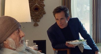 Movie still from “The Meyerowitz Stories” (2017), directed by Noah Baumbach – A man sitting at a table with a bowl of food; Medium shot, Over the shoulder angle