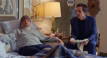 Movie still from “The Meyerowitz Stories” (2017), directed by Noah Baumbach – A man in a hospital bed holding a tray of food; Medium shot, Over the shoulder angle