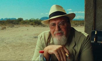 Movie still from “Paris, Texas” (1984), directed by Wim Wenders – An older man wearing a hat and sunglasses; Close Up shot, Low angle