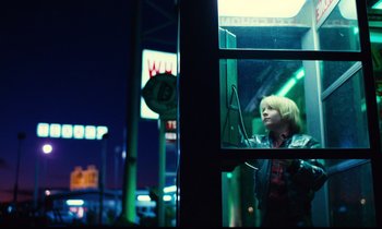 Movie still from “Paris, Texas” (1984), directed by Wim Wenders – A young boy looking out of a window at night; Wide shot, Low angle