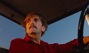 Movie still from “Paris, Texas” (1984), directed by Wim Wenders – A person wearing a red shirt; Close Up shot, Low angle