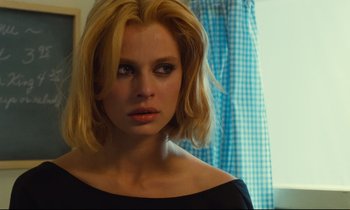 Movie still from “Paris, Texas” (1984), directed by Wim Wenders – A woman with blonde hair looking at the camera; Close Up shot, Over the shoulder angle