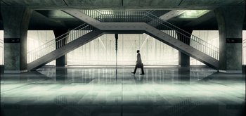 Movie still from “The Midnight Sky” (2020), directed by George Clooney – A man in a suit is walking in a building; Extreme Wide shot, Low angle