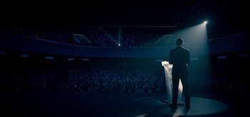 Movie still from “The Midnight Sky” (2020), directed by George Clooney – A man standing at a podium in front of an audience; Extreme Wide shot, High angle