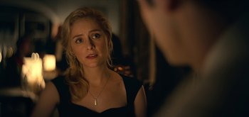 Movie still from “The Midnight Sky” (2020), directed by George Clooney – A woman in a black dress looking at a man in a black suit; Close Up shot, Over the shoulder angle