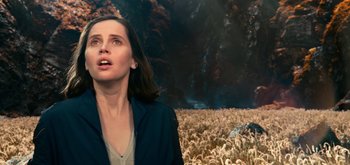 Movie still from “The Midnight Sky” (2020), directed by George Clooney – A woman standing in the middle of an open field; Close Up shot, Over the shoulder angle